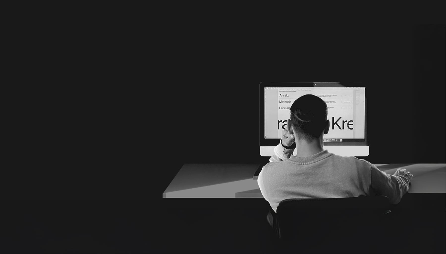 Seid working at a desk in a dark room